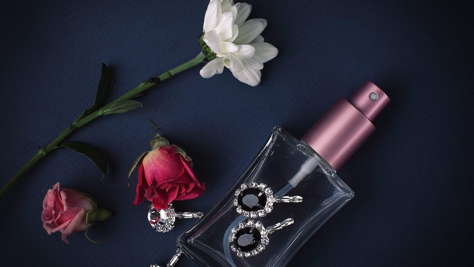 A small perfume bottle with flowers